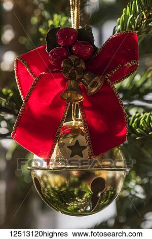 Golden bauble with ribbon on Christmas tree; London, England View Large Photo Image Stock Photograph - Golden bauble with ribbon on Christmas tree; London, England. Fotosearch