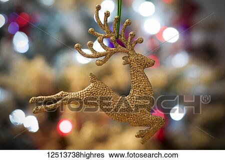 Golden reindeer on Christmas tree with lights; London, England View Large Photo Image Stock Photograph - Golden reindeer on Christmas tree with lights; London, England. Fotosearch