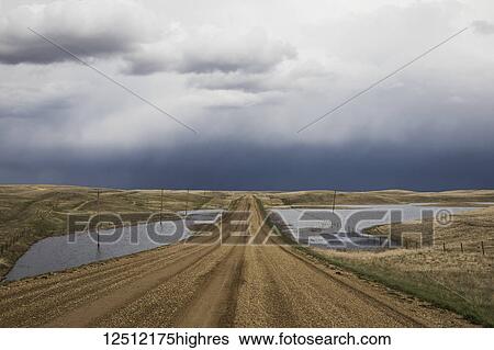 Gravel road heading towards a stormy sky in Southwestern Saskatchewan; Val Marie, Saskatchewan, Canada View Large Photo Image Stock Photograph - Gravel road heading towards a stormy sky in Southwestern Saskatchewan; Val Marie, Saskatchewan, Canada. Fotosearch