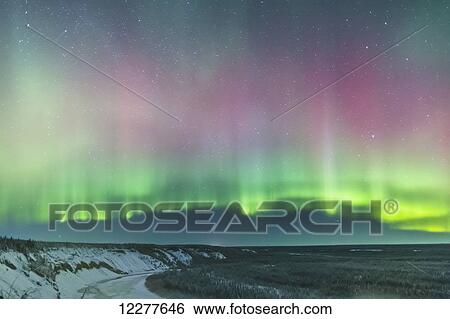 Stock Photograph - Green and red northern lights over the Copper River near Glennallen, Southcentral Alaska, USA, Winter. Fotosearch