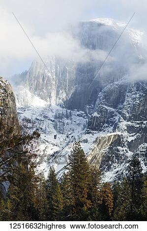 Stock Photograph - Half Dome with snow and clouds, Yosemite National Park, California, United States of America. Fotosearch