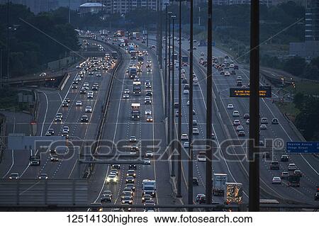 Stock Photograph - Highway 401 looking West towards Yonge Street at dusk; Toronto, Ontario, Canada. Fotosearch