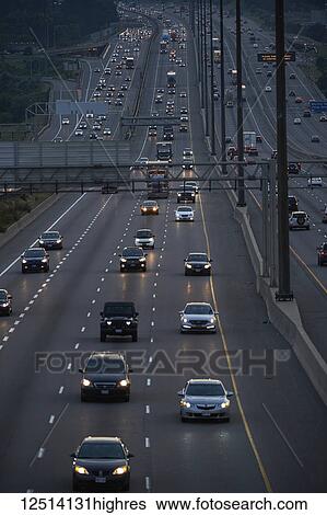 Stock Photograph - Highway 401 looking West towards Yonge Street at dusk; Toronto, Ontario, Canada. Fotosearch