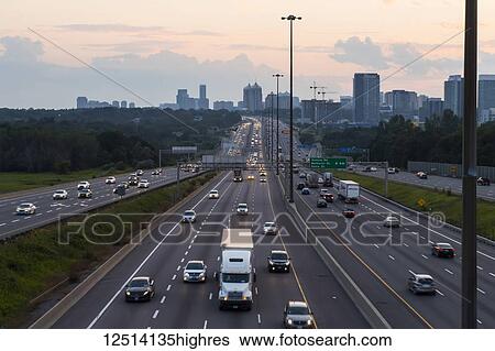 Stock Photograph - Highway 401 looking West towards Yonge Street at dusk; Toronto, Ontario, Canada. Fotosearch