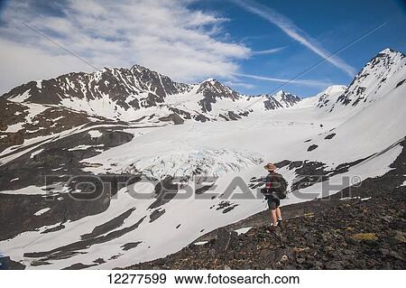 Hiker on Crow Pass Trail, in Chugach State Park near Girdwood, Southcentral Alaska, Summer. View Large Photo Image Stock Photo - Hiker on Crow Pass Trail, in Chugach State Park near Girdwood, Southcentral Alaska, Summer.. Fotosearch