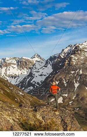 Hiker on rock outcrop overlooks Powerline Pass valley and trail, Chugach State Park, Southcentral Alaska View Large Photo Image Stock Image - Hiker on rock outcrop overlooks Powerline Pass valley and trail, Chugach State Park, Southcentral Alaska. Fotosearch