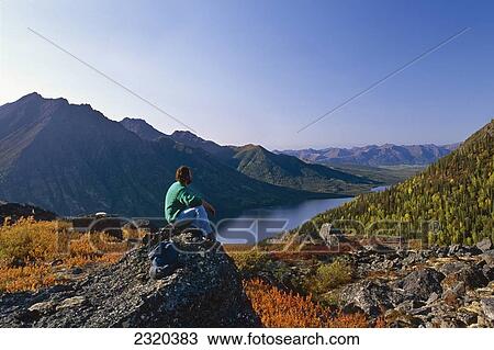 Hiker Sitting On Rock Above Selby Lake Brooks Range Gates Of The Arctic National Park Autumn Alaska/N View Large Photo Image Stock Image - Hiker Sitting On Rock Above Selby Lake Brooks Range Gates Of The Arctic National Park Autumn Alaska/N. Fotosearch