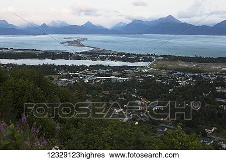 Homer Spit, Kachemak Bay and the Kenai Mountains under a cloudy sky; Homer, Alaska, United States of America View Large Photo Image Stock Photograph - Homer Spit, Kachemak Bay and the Kenai Mountains under a cloudy sky; Homer, Alaska, United States of America. Fotosearch