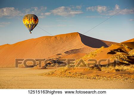 Hot air balloon ride over the red sand dunes of Sossusvlei in Namibia; Sossusvlei, Hardap Region, Namibia View Large Photo Image Stock Photograph - Hot air balloon ride over the red sand dunes of Sossusvlei in Namibia; Sossusvlei, Hardap Region, Namibia. Fotosearch