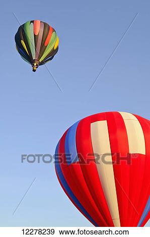 Hot air balloons in the blue sky; Woodburn, Oregon, United States of America View Large Photo Image Stock Photo - Hot air balloons in the blue sky; Woodburn, Oregon, United States of America. Fotosearch