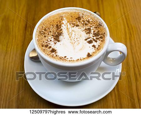 Hot chocolate in white cup with saucer and a leaf pattern in the white foam sprinkled with chocolate; British Columbia, Canada View Large Photo Image Stock Photograph - Hot chocolate in white cup with saucer and a leaf pattern in the white foam sprinkled with chocolate; British Columbia, Canada. Fotosearch