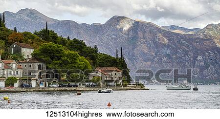 Stock Photograph - Houses and boats along the Bay of Kotor; Perast, Kotor, Monte. Fotosearch