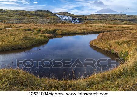 Stock Photograph - Husarfoss waterfall in a remote landscape; Djupavik, West Fjords, Iceland. Fotosearch