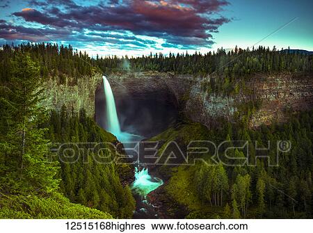 Illuminated waterfall flowing over a cliff in Wells Grey Provincial Park; Thompson-Nicola Regional District, British Columbia, Canada View Large Photo Image Stock Photograph - Illuminated waterfall flowing over a cliff in Wells Grey Provincial Park; Thompson-Nicola Regional District, British Columbia, Canada. Fotosearch