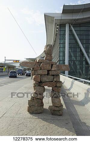 Stock Photography - Inukshuk statue outside departures at Toronto Pearson International Airport; Toronto, Ontario, Canada. Fotosearch