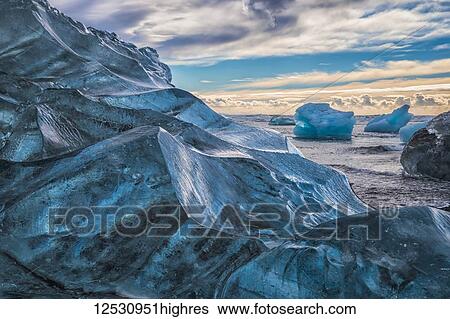 Jokulsarlon or Diamond Beach, with large chunks of ice littering the beach between each high tide; Iceland View Large Photo Image Stock Photograph - Jokulsarlon or Diamond Beach, with large chunks of ice littering the beach between each high tide; Iceland. Fotosearch