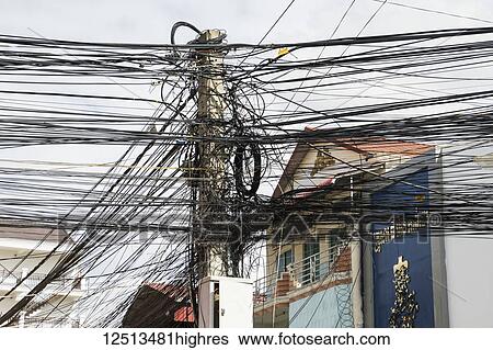 Stock Photograph - Lamppost with numerous wires and cables; Phnom Penh, Cambodia. Fotosearch