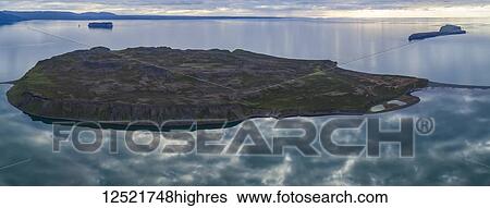Land formation in the Atlantic Ocean off the coast of Northern Iceland; Hofsos, Iceland View Large Photo Image Stock Photograph - Land formation in the Atlantic Ocean off the coast of Northern Iceland; Hofsos, Iceland. Fotosearch