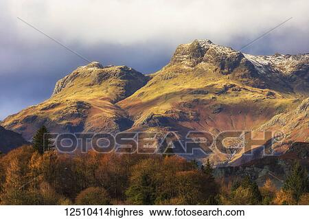 Langdale Pikes, rugged mountains with autumn coloured trees in the valley; Langdale, Cumbria, England View Large Photo Image Stock Photograph - Langdale Pikes, rugged mountains with autumn coloured trees in the valley; Langdale, Cumbria, England. Fotosearch