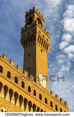 Large stone clock tower on top of castle walls with dramatic clouds and blue sky; Florence, Tuscany, Italy View Large Photo Image Stock Photograph - Large stone clock tower on top of castle walls with dramatic clouds and blue sky; Florence, Tuscany, Italy. Fotosearch