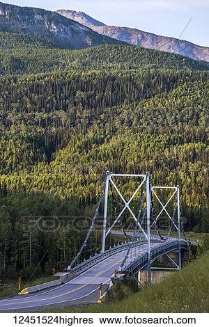 Stock Photograph - Liard River suspension bridge, last suspension bridge on the Alaska Highway; Liard, British Columbia, Canada. Fotosearch