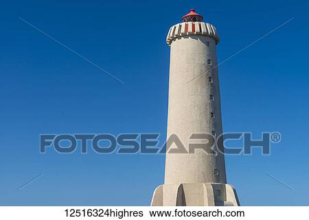 Stock Photograph - Lighthouse against a bright, blue sky; Akranes, Iceland. Fotosearch