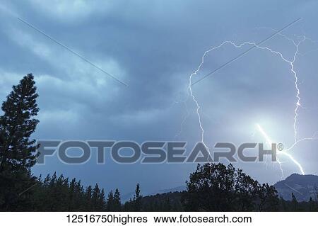 Stock Photograph - Lightning bolt strikes in this spectacular early morning image, Cascade Siskiyou National Monument; Ashland, Oregon, United States of America. Fotosearch