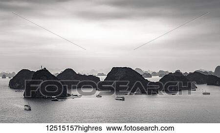 Limestone karsts and boats in Ha Long Bay; Thanh pho Ha Long, Quang Ninh, Vietnam View Large Photo Image Stock Photograph - Limestone karsts and boats in Ha Long Bay; Thanh pho Ha Long, Quang Ninh, Vietnam. Fotosearch