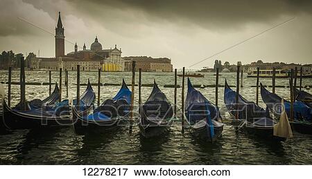 Stock Photo - Line of gondolas in the canal; Venice, Itay. Fotosearch