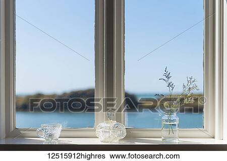 Stock Photograph - Looking out window to blue skies, sea and headland; Borgarnes, Iceland. Fotosearch