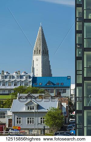 Stock Photograph - Looking past flats and houses to the Hallgrimskirkja (Hallgrimur church); Reykjavik, Iceland. Fotosearch