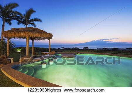 Stock Photograph - Luxury Home With Swimming Pool At Sunset. Fotosearch