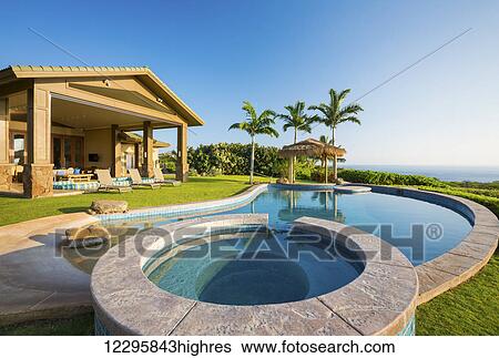 Stock Photograph - Luxury Home With Swimming Pool. Fotosearch