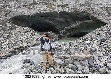 Male hiker takes a self-portrait with his cell phone in front of a Gulkana Glacier ice cave; Alaska, United States of America View Large Photo Image Stock Photograph - Male hiker takes a self-portrait with his cell phone in front of a Gulkana Glacier ice cave; Alaska, United States of America. Fotosearch
