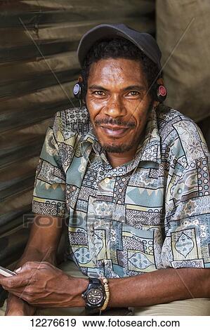 Man at the market; Dili, East Timor View Large Photo Image Stock Photo - Man at the market; Dili, East Timor. Fotosearch