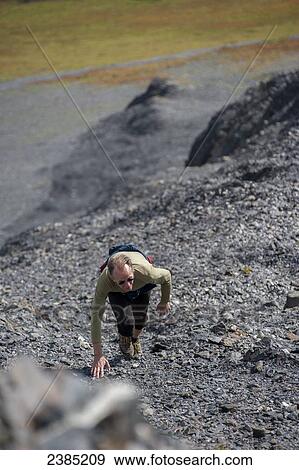 Man hiking the steep shale cliffs above treeline on the Mount Marathon trail, Seward, Seward, Summer, Southcentral Alaska View Large Photo Image Stock Photo - Man hiking the steep shale cliffs above treeline on the Mount Marathon trail, Seward, Seward, Summer, Southcentral Alaska. Fotosearch