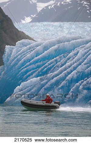 Man Motoring In Zodiac Across Face Of Iceberg Ak Se Summer View Large Photo Image Stock Photography - Man Motoring In Zodiac Across Face Of Iceberg Ak Se Summer. Fotosearch