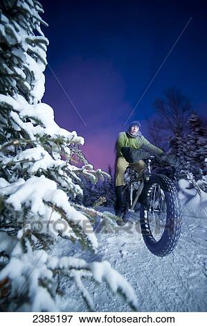 Man snow biking on the Speedway trail, Far North Bicentennial Park, Anchorage, Alaska View Large Photo Image Stock Photo - Man snow biking on the Speedway trail, Far North Bicentennial Park, Anchorage, Alaska. Fotosearch