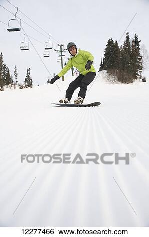 Man snowboards at Hilltop Ski Area in Anchorage, Alaska View Large Photo Image Stock Photograph - Man snowboards at Hilltop Ski Area in Anchorage, Alaska. Fotosearch