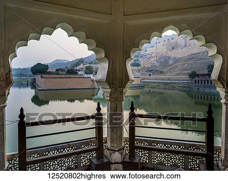 Stock Photograph - Maota Lake in front of Amer Fort viewed through scalloped archways; Jaipur, Rajasthan, India. Fotosearch