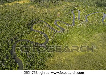Stock Photograph - Meandering stream winding its way through the Yukon wilderness; Yukon Territory, Canada. Fotosearch