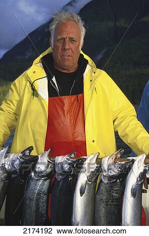 Stock Image - Men Holding Silver Salmon Cleveland Peninsula Se Ak Summer Portrait. Fotosearch