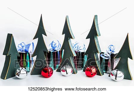 Miniature wooden trees, bells and wrapped gifts as decorations for Christmas View Large Photo Image Stock Photograph - Miniature wooden trees, bells and wrapped gifts as decorations for Christmas. Fotosearch