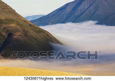 Stock Photograph - Morning fog blankets the lower Valley of Ten Thousand Smokes in Katmai National Park; Alaska, United States of America. Fotosearch