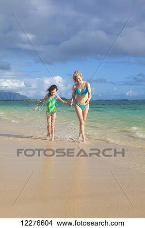 Mother and daughter at the beach; Kailua, Island of Hawaii, Hawaii, United States of America View Large Photo Image Picture - Mother and daughter at the beach; Kailua, Island of Hawaii, Hawaii, United States of America. Fotosearch