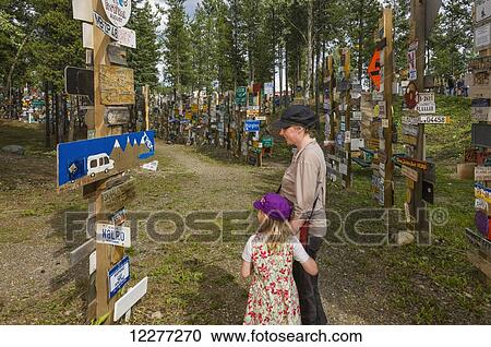 Mother and daughter explore the Signpost Forest, Watson Lake, Yukon Territory, Canada, summer View Large Photo Image Stock Image - Mother and daughter explore the Signpost Forest, Watson Lake, Yukon Territory, Canada, summer. Fotosearch