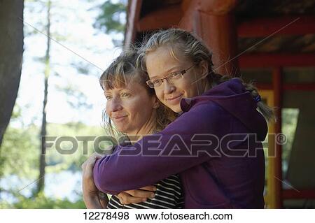 Mother and daughter in an embrace; Lac des Neiges, Quebec, Canada View Large Photo Image Stock Photo - Mother and daughter in an embrace; Lac des Neiges, Quebec, Canada. Fotosearch