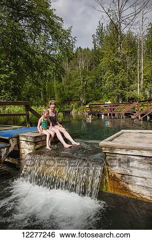 Stock Photograph - Mother and daughter in Liard Hot Springs, British Columbia, Canada, summer. Fotosearch