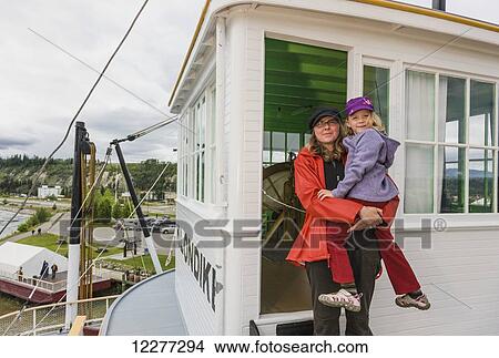 Mother and daughter outside on the deck of the SS Klondike, Whitehorse, Yukon Territory, Canada, Summer View Large Photo Image Picture - Mother and daughter outside on the deck of the SS Klondike, Whitehorse, Yukon Territory, Canada, Summer. Fotosearch