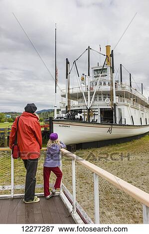 Mother and daughter stand on a viewing platform looking at the SS Klondike, Whitehorse, Yukon Territory, Canada, summer View Large Photo Image Stock Photo - Mother and daughter stand on a viewing platform looking at the SS Klondike, Whitehorse, Yukon Territory, Canada, summer. Fotosearch